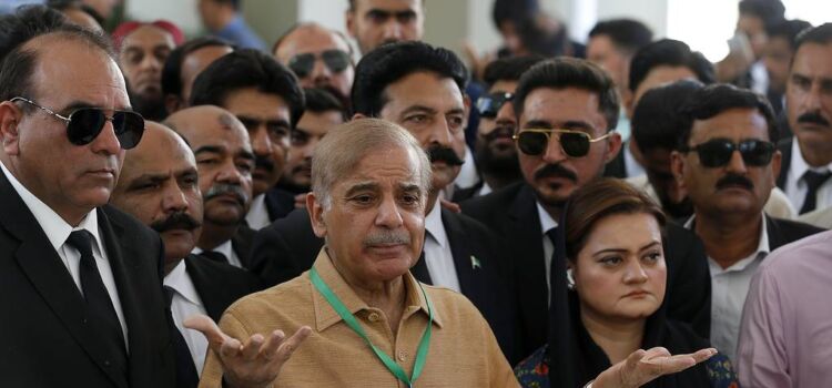 Pakistan's opposition leader Shahbaz Sharif, center, talks to