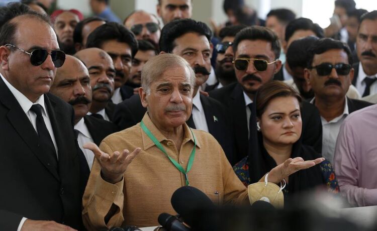 Pakistan's opposition leader Shahbaz Sharif, center, talks to